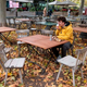 Man eats food in abandoned restaurant patio area